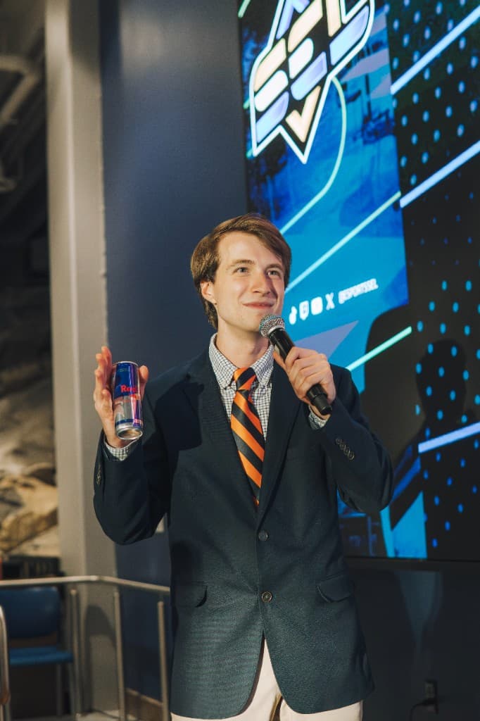 Gaming Oasis Director of League Operations on the SEL stage presenting a sponsor product during a live broadcast